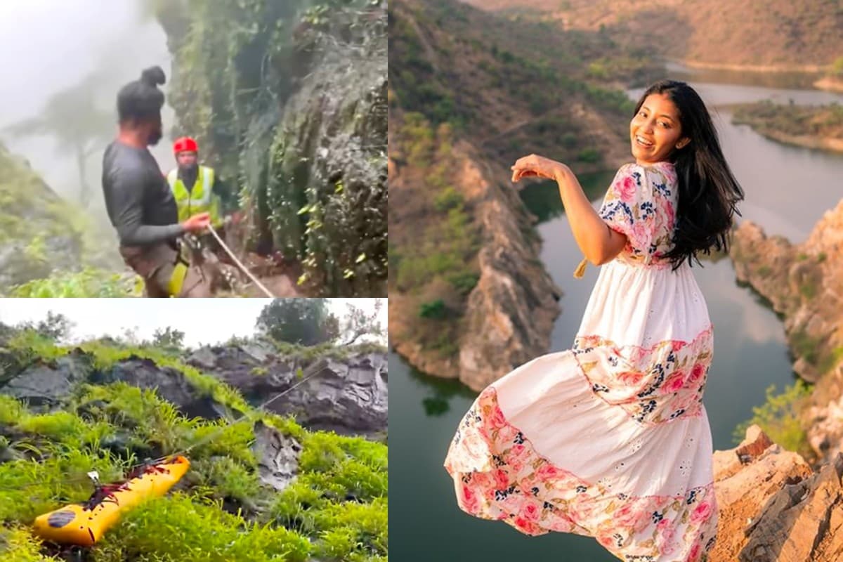 Aanvi Kamdar, the travel influencer, smiling in front of a scenic waterfall backdrop.